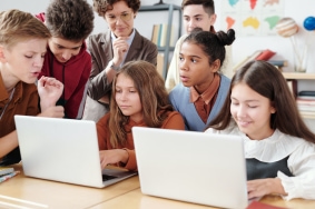 kids looking at laptops