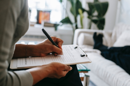 woman writing on a paper