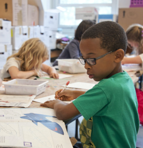 students drawing on a table